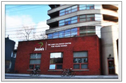 red brick building with sign "Jessie's The June Callwood Centre for Young Women" and bicycles parked out front