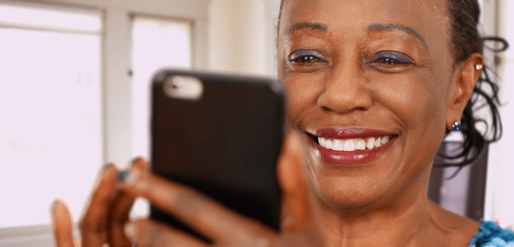 close up of senior female using mobile phone