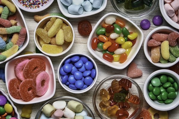 Bowls of multicolored candies sorted by type