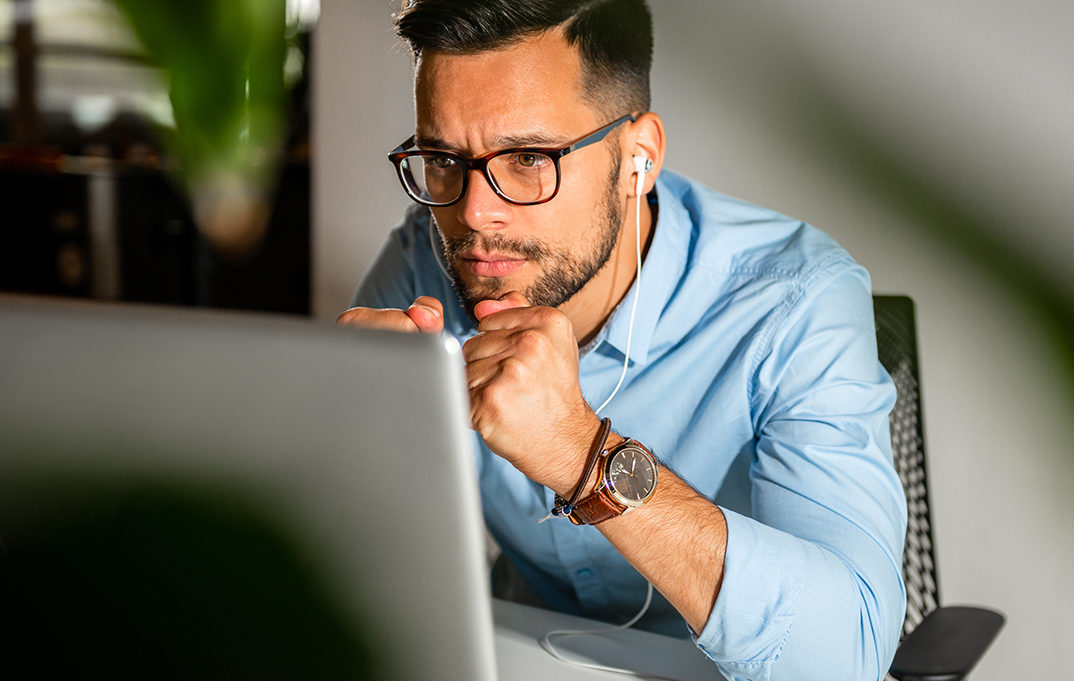 Young man waitting for a good news, while reading laptop