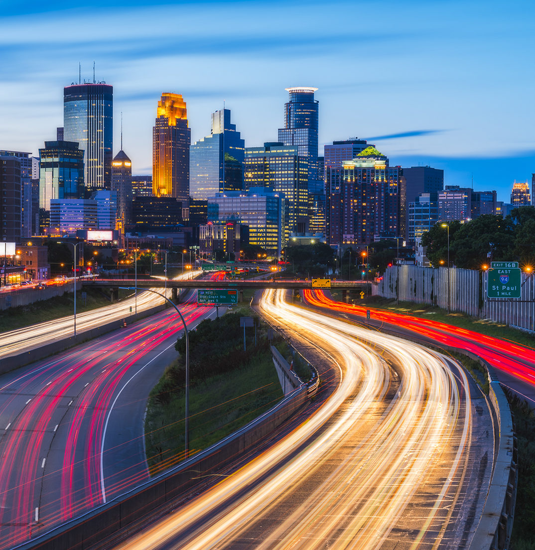 Minneapolis skyline with traffic light at night.