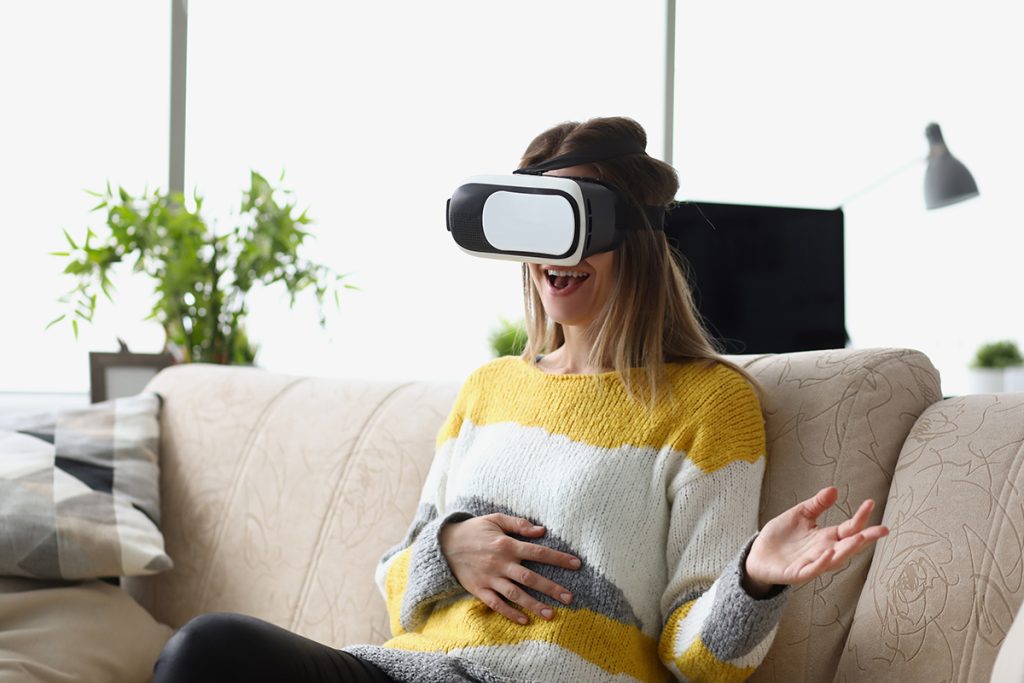Portrait of female sit on sofa wear vr glasses modern device, enjoy spare time in imagination world. Visual effects, fun leisure. Entertainment concept